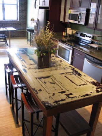 A KITCHEN ISLAND MADE FROM AN OLD DOOR