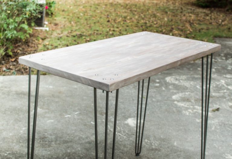 A STANDING DESK WITH WOOD TOP METAL LEGS